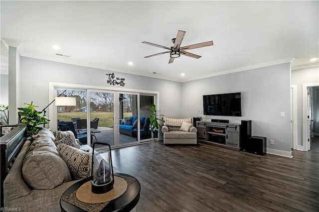 living room with dark wood-type flooring, ceiling fan, and crown molding