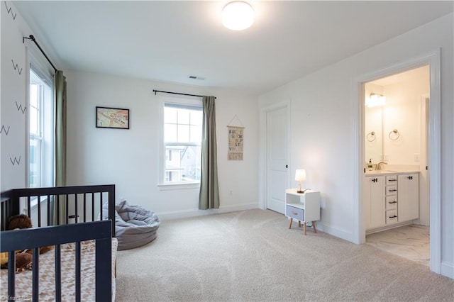 bedroom with baseboards, visible vents, and light carpet