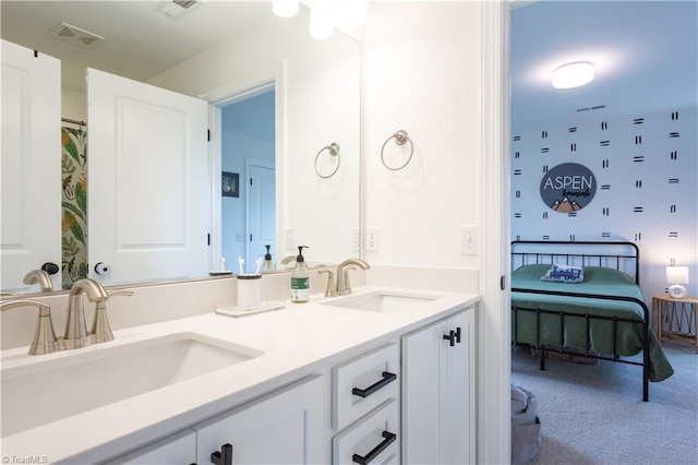 full bathroom featuring a sink, visible vents, and double vanity