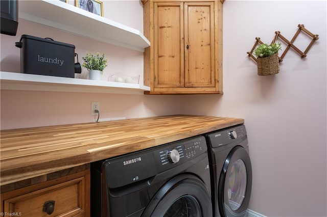 washroom with cabinet space and washer and dryer