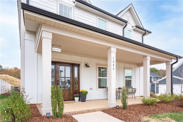 entrance to property featuring covered porch and board and batten siding