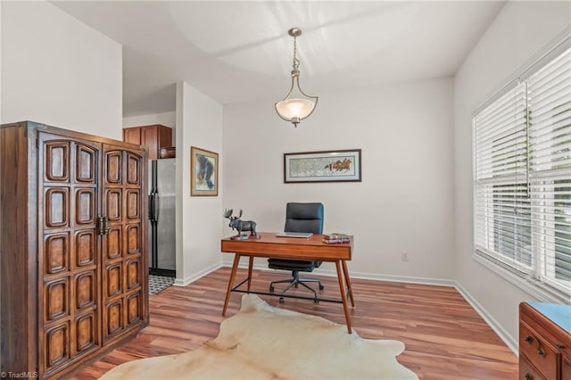 office area with light hardwood / wood-style floors