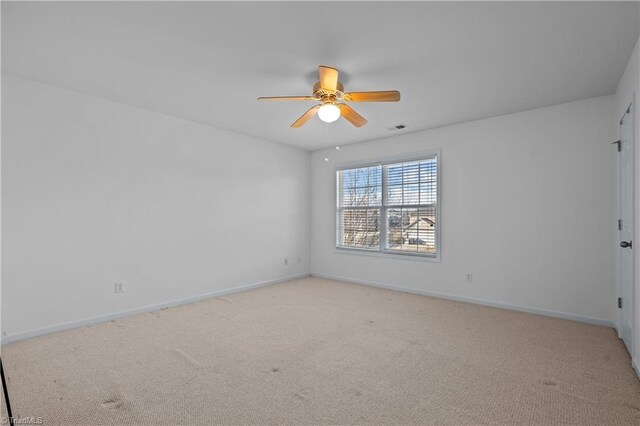 unfurnished room with ceiling fan and light carpet