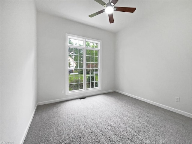 unfurnished room featuring healthy amount of natural light, carpet, ceiling fan, and baseboards