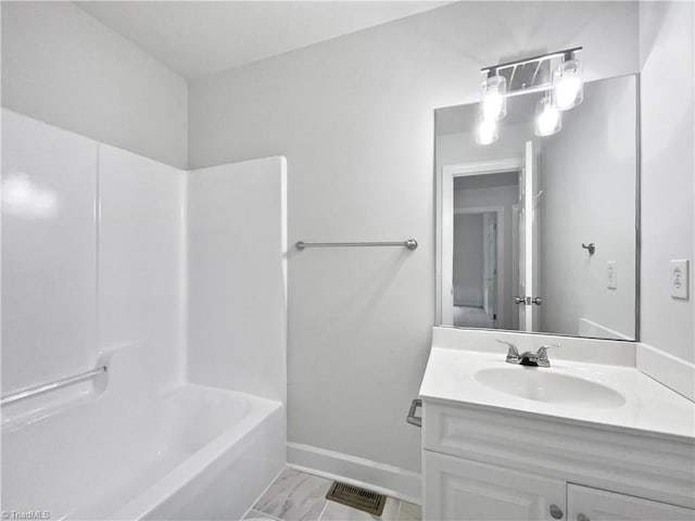 bathroom with vanity, marble finish flooring, shower / bath combination, and baseboards