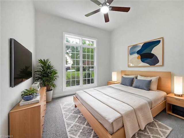 carpeted bedroom featuring multiple windows, ceiling fan, and baseboards