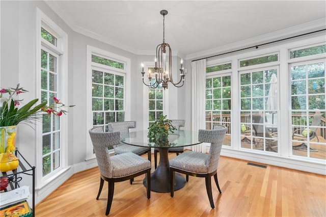 sunroom with a wealth of natural light and a notable chandelier