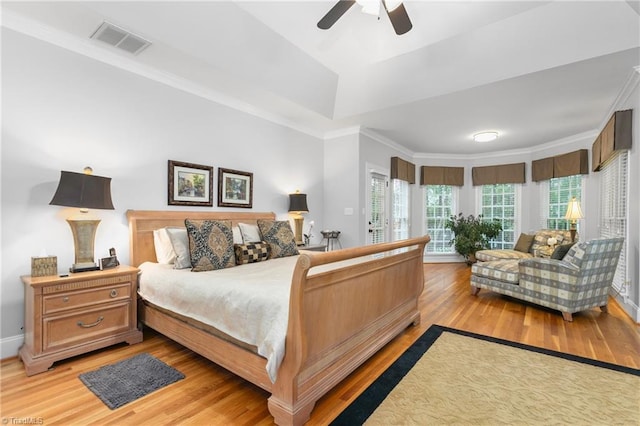 bedroom featuring light wood-type flooring, ceiling fan, and crown molding