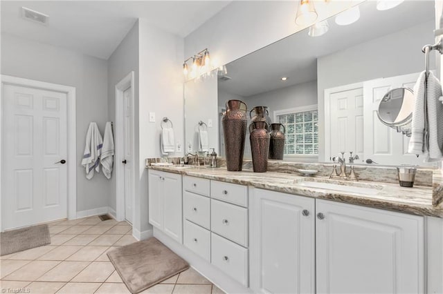 bathroom with tile patterned floors and vanity