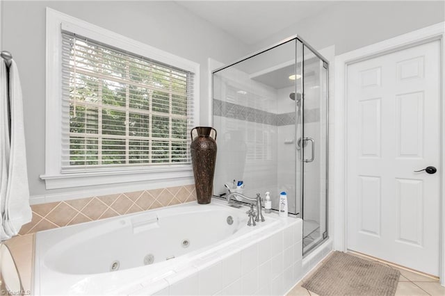 bathroom with tile patterned flooring and shower with separate bathtub