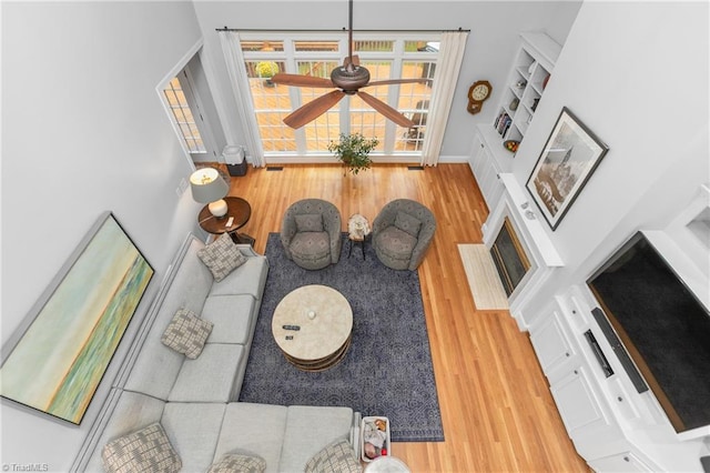 living room with hardwood / wood-style flooring and ceiling fan