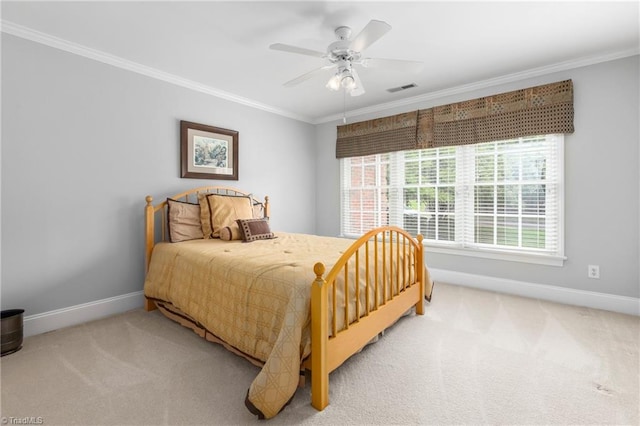 carpeted bedroom with ceiling fan and crown molding