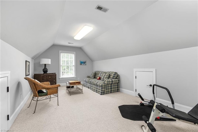 exercise room featuring light carpet and vaulted ceiling