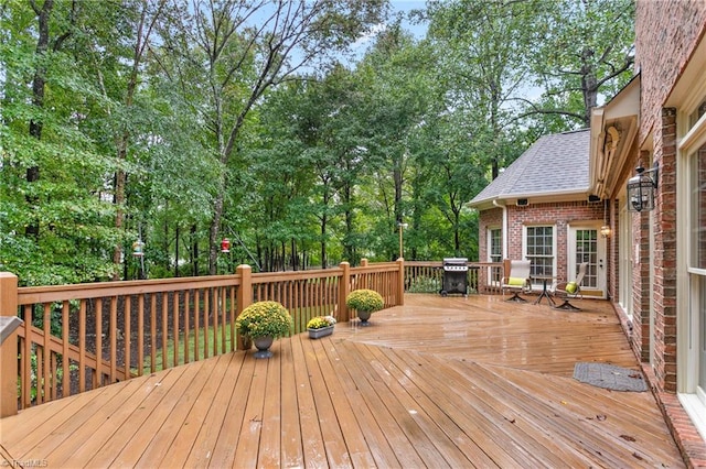 wooden deck featuring area for grilling