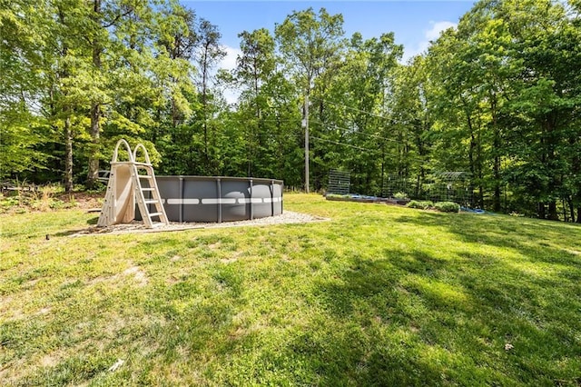view of yard featuring an outdoor pool