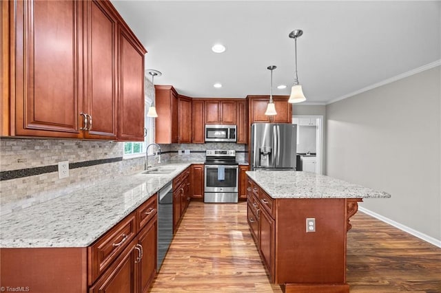 kitchen featuring light wood-style floors, a sink, tasteful backsplash, and stainless steel appliances