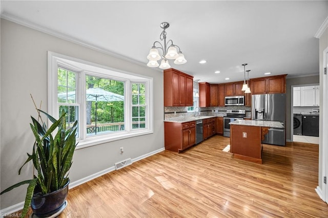 kitchen featuring visible vents, plenty of natural light, crown molding, and stainless steel appliances