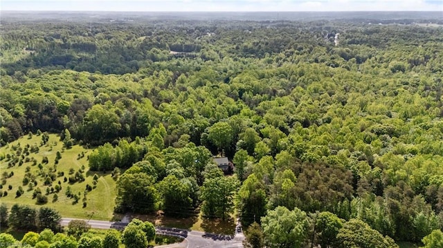 drone / aerial view featuring a wooded view