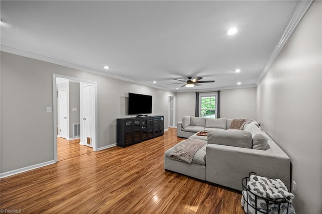 living area featuring ornamental molding, wood finished floors, baseboards, ceiling fan, and recessed lighting