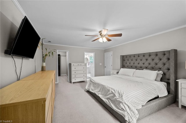bedroom featuring crown molding, light carpet, a ceiling fan, and a spacious closet
