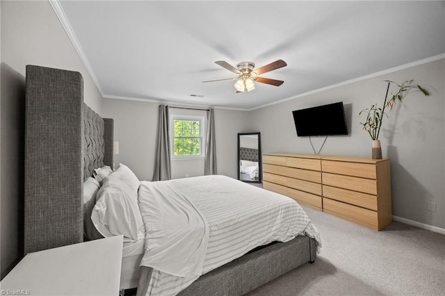 bedroom with a ceiling fan, visible vents, crown molding, baseboards, and carpet flooring
