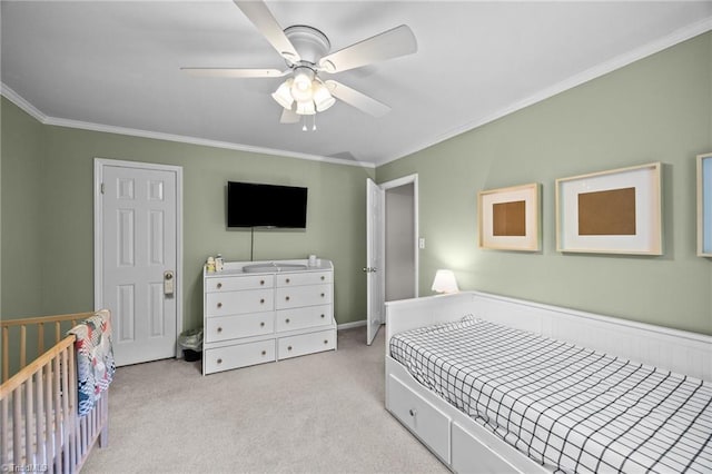 bedroom featuring light colored carpet, ornamental molding, and ceiling fan