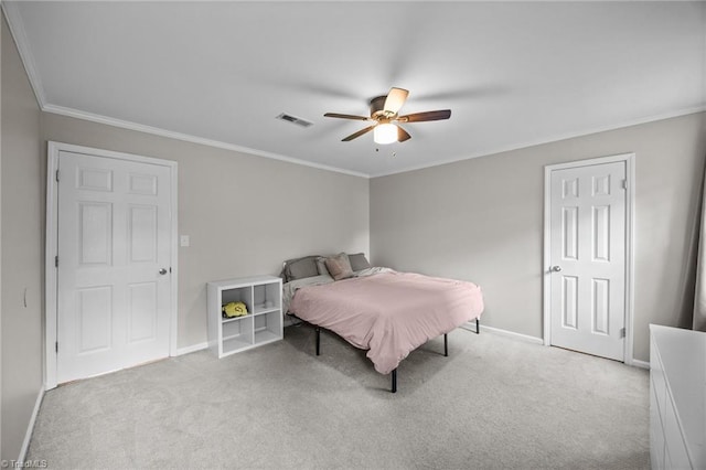 carpeted bedroom featuring visible vents, ornamental molding, baseboards, and ceiling fan