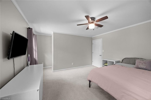carpeted bedroom featuring baseboards, ornamental molding, and a ceiling fan