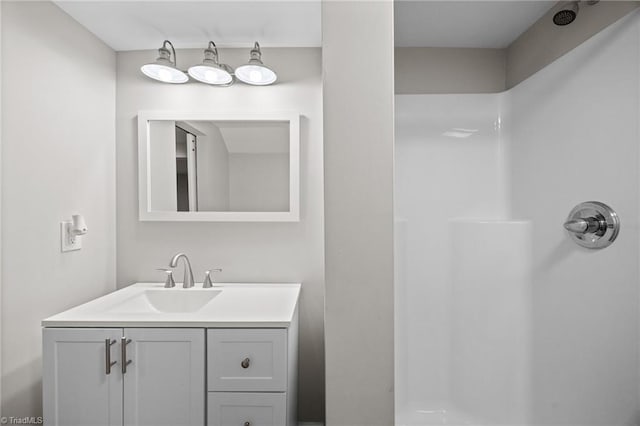 bathroom with walk in shower and vanity