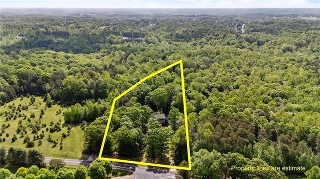birds eye view of property with a forest view