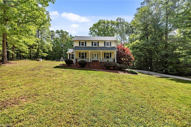 colonial inspired home with covered porch and a front yard