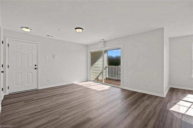 empty room with dark hardwood / wood-style floors