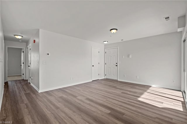 empty room featuring wood-type flooring