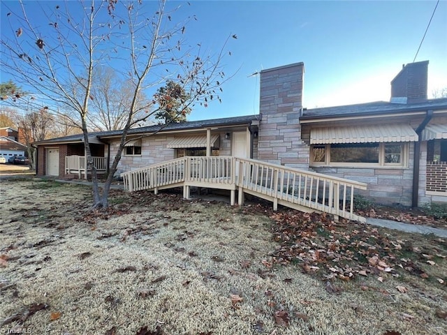 back of property with a porch and a wooden deck