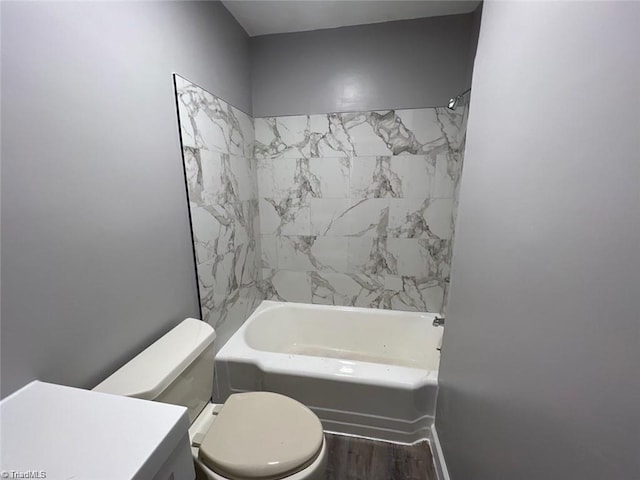 full bathroom featuring toilet, tiled shower / bath combo, and vanity