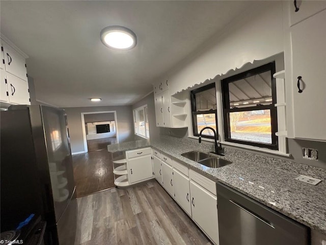 kitchen featuring sink, appliances with stainless steel finishes, wood-type flooring, and white cabinets