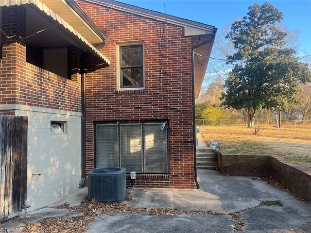 rear view of property with cooling unit