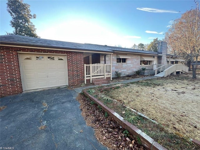 single story home featuring a porch and a garage