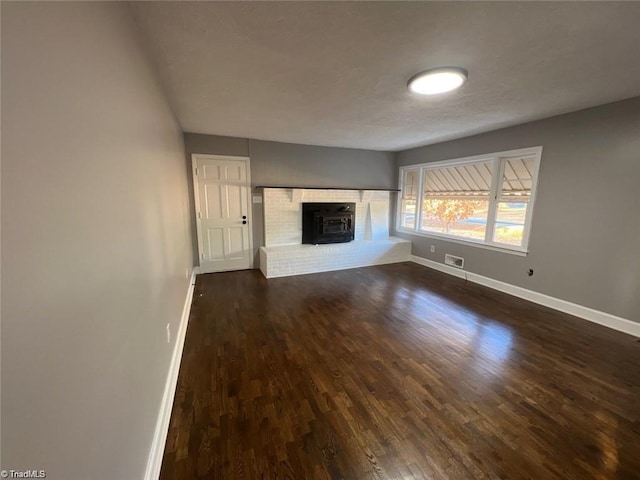 unfurnished living room featuring dark hardwood / wood-style floors