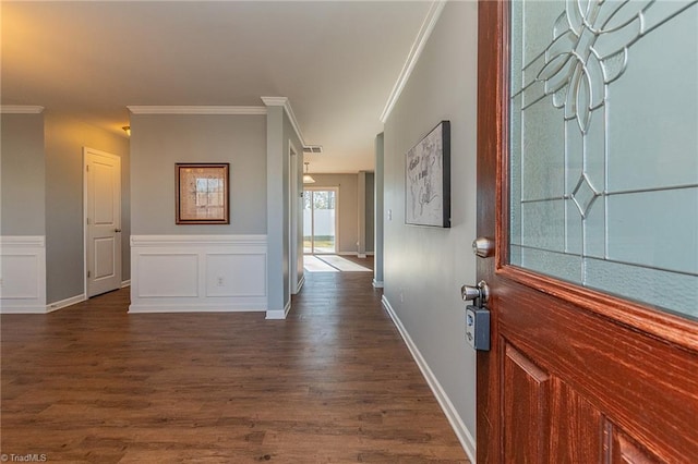 entryway with crown molding and dark wood-type flooring