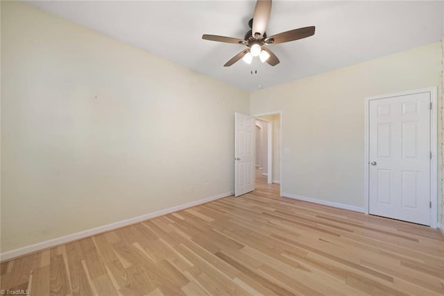 unfurnished bedroom featuring light wood-style floors, baseboards, and a ceiling fan