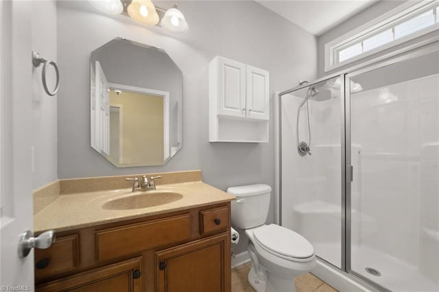 bathroom with toilet, a shower stall, tile patterned flooring, and vanity