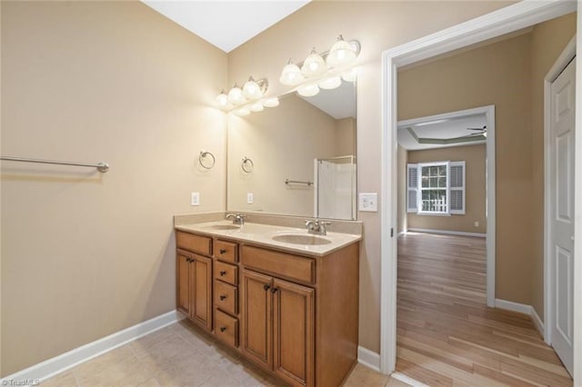 bathroom with a sink and baseboards