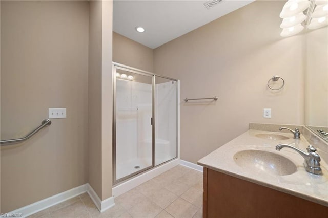 full bathroom with a sink, tile patterned floors, and a shower stall