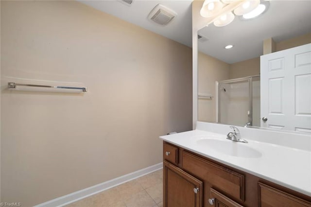 full bathroom featuring visible vents, vanity, baseboards, tile patterned floors, and a shower stall