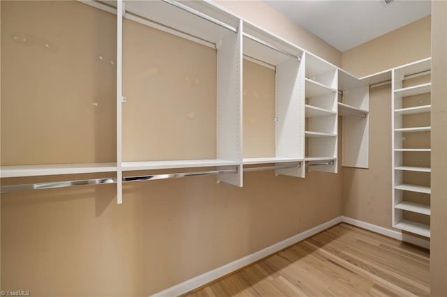 spacious closet with wood finished floors