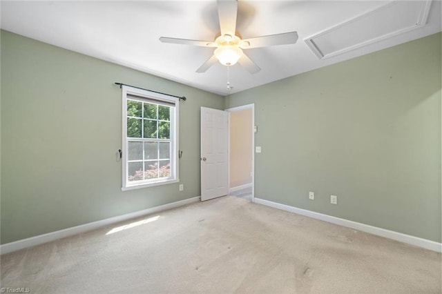 unfurnished room with ceiling fan, light carpet, and baseboards