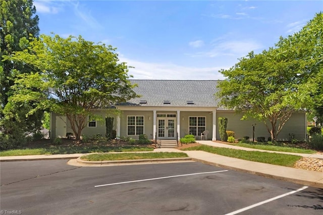ranch-style house with uncovered parking and french doors