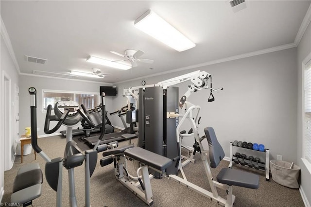 gym featuring baseboards, ornamental molding, and a wealth of natural light