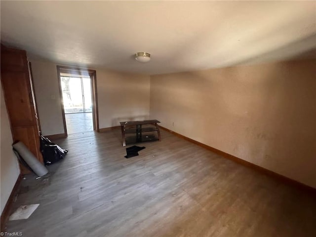 interior space featuring baseboards and wood finished floors